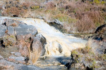 Water flows over creamy white rocks in The Silica Rapids