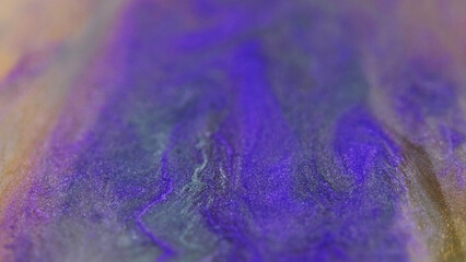 Glitter emulsion. Defocused pigment flow. Glistening texture filled sparkling gold black purple yellow color ink particles abstract background.