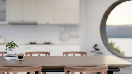 A space for displaying products on a wooden dining table in a minimalist white kitchen.