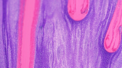 Glitter drop. Shiny ink. Defocused pink purple color spilling sparkling particles on gel paint flow...