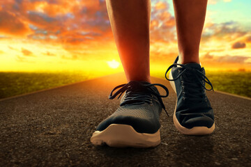 Naklejka premium Closeup silhouette of young man legs step walk on the street in the morning