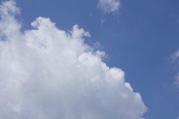 A blue sky with puffy clouds.