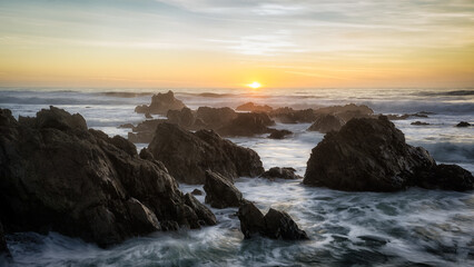 The sun sets over the ocean horizon in Lucia, California