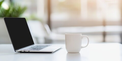 Fototapeta premium Blurred Modern Office Interior with Laptop and Coffee Cup on White Table, Minimalist Home Workspace for Online Education or Remote Business Concepts