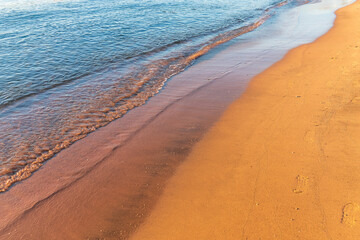 Soft wave of the sea on the sandy beach.
