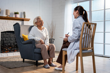 Asian young caregiver nurse examine and listen to senior woman patient. 