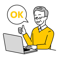 OKサインをするノートパソコンで仕事をしている年配の男性