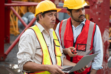 Asia engineer man worker use tablet computer and India engineer man use walkie talkie working with...