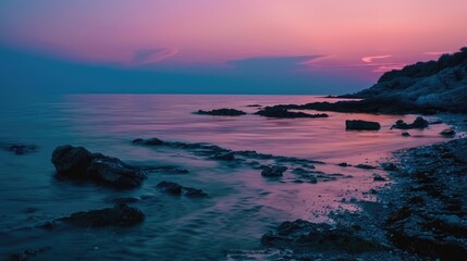 Fototapeta premium The sky glows with orange-pink shades at twilight, as moonlight reflects on calm waters, setting a romantic and mysterious mood by the seashore