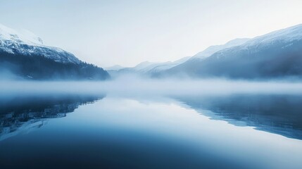Fototapeta premium Serene Dawn Mountain Lake with Mist and Snow-Capped Peaks