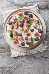 Italian fig and blackberry cake with cream cheese close-up in a plate on the table. Vertical top view from above