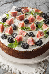 Fresh Fig Blackberry and Ricotta Cake closeup on the plate on the table. Vertical