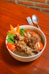 beef soup. served with broth and fresh vegetables as a complement