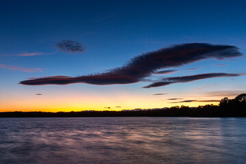 Landscape with the waters of the Valparaíso Reservoir, forests and sky with clouds at sunset, Zamora, Castilla y León, Spain.