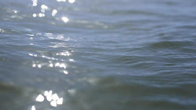 Light Reflects off the calm water on a beautiful beach day in The Hamptons on the Eastern end of Long Island, New York