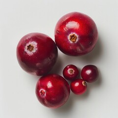 Obraz premium three pomegranates on a white surface with one cut in half