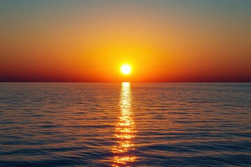 Golden sunset over a calm sea, clear weather, warm glow on the horizon