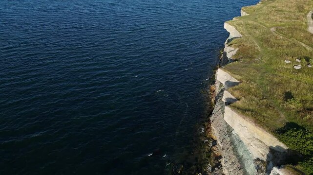 Top-down aerial view of Pakri Cliff in Paldiski, Estonia near Tallinn, captured during a sunny evening showcasing dramatic coastal formations.