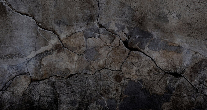 Kaputte dunkle Steinwand mit Rissen als Hintergrund