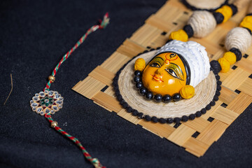 Subho mahalaya, hindu goddess durga idol necklace painted with yellow color and colordul rakhi with...