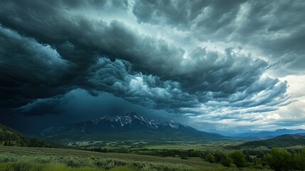 Fototapeta premium Dramatic storm clouds over a mountain range, with plenty of room for text.