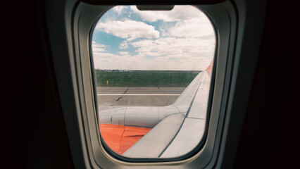 view from the airplane window of the airport during takeoff