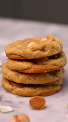 The cookies are golden brown with a slightly crispy edge and a soft, chewy center. Some cookies have chocolate chips