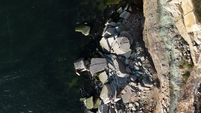 Top-down aerial view of Pakri Cliff in Paldiski, Estonia near Tallinn, captured during a sunny evening showcasing dramatic coastal formations.