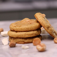 The cookies are golden brown with a slightly crispy edge and a soft, chewy center. Some cookies have chocolate chips