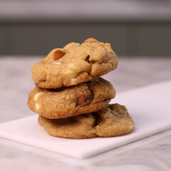 The cookies are golden brown with a slightly crispy edge and a soft, chewy center. Some cookies have chocolate chips
