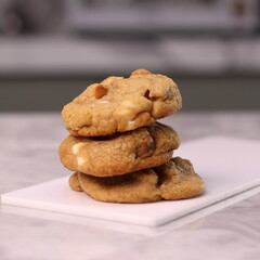 The cookies are golden brown with a slightly crispy edge and a soft, chewy center. Some cookies have chocolate chips