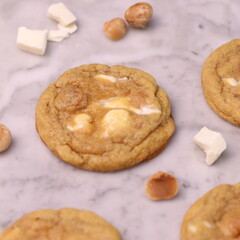 The cookies are golden brown with a slightly crispy edge and a soft, chewy center. Some cookies have chocolate chips