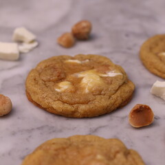 The cookies are golden brown with a slightly crispy edge and a soft, chewy center. Some cookies have chocolate chips