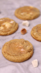 The cookies are golden brown with a slightly crispy edge and a soft, chewy center. Some cookies have chocolate chips