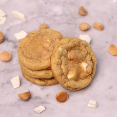 The cookies are golden brown with a slightly crispy edge and a soft, chewy center. Some cookies have chocolate chips