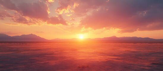 Obraz premium Stunning Sunset Over Desert Landscape with Dramatic Clouds and Distant Mountains