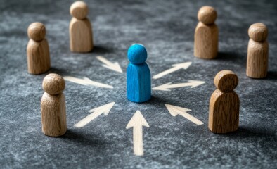 Wooden figures of people stand in an array around the blue figure