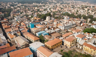Fototapeta premium Drone flying above densely populated city showing colorful houses and businesses