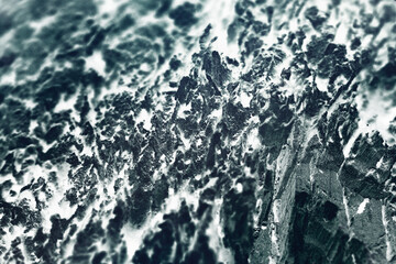 ミニチュアワールド風、漆黒と濃藍色の凍った山の岩壁イメージ（レタッチ＆色彩加工素材）