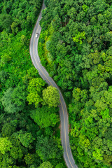 Aerial view of road in the middle of the forest , Top view road curve construction up to mountain, Rainforest ecosystem and healthy environment concept