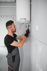 Professional plumber servicing a boiler