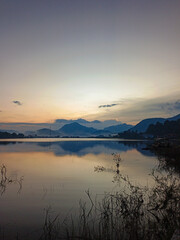 reflection of the evening sunset on a beautiful lake background with a blue orange sky