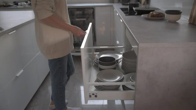 A person is engaging with a sleek and modern kitchen appliance, which effectively showcases contemporary design