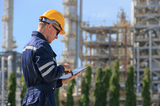 Refinery petroleum worker on duty radio control operation. Industrial Engineer in oil and gas working in petrochemical plant.