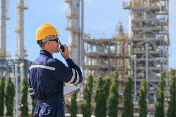 Refinery petroleum worker on duty radio control operation. Industrial Engineer in oil and gas...