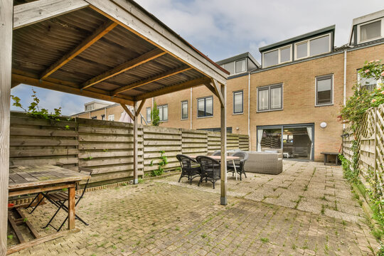Spacious backyard patio with furniture and pergola