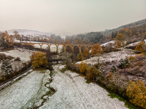 old train stone bridge in the mountains over the river in snow landscape Jur&eacute; France