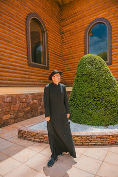 Catholic priest outside an Orthodox church in Altea, Spain