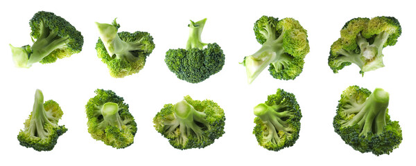 Multiple broccoli florets arranged in a line, showcasing various sizes and angles, isolated on a white background.
