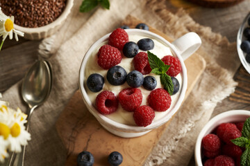 A bowl of cottage cheese with flax seed oil with fresh blueberries and raspberries